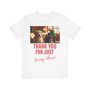 White t-shirt with a photo of a dog and parrot and text 'THANK YOU FOR JUST being there' on a white background
