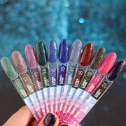 Nail polish bottle with 'Luna' branding and a black glittery nail sample on a pink background