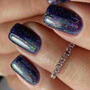 Nail polish bottle with 'Luna' branding and a black glittery nail sample on a pink background